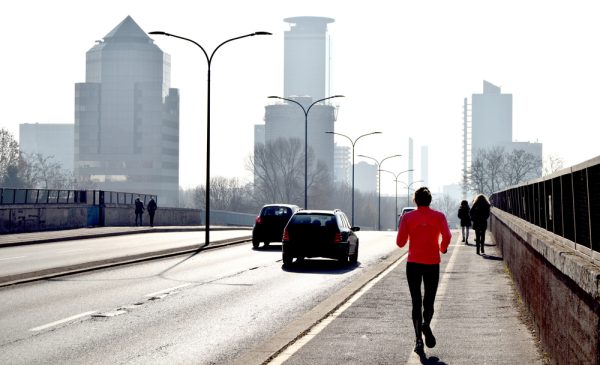 Man running along bridge
